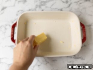 preparing a baking dish for rice pudding by buttering it