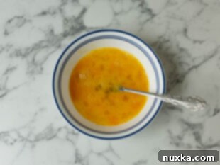 beating eggs with a fork for rice pudding