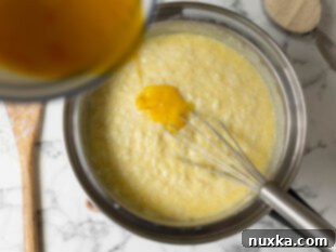 mixing eggs and sugar into thickened rice and milk mixture