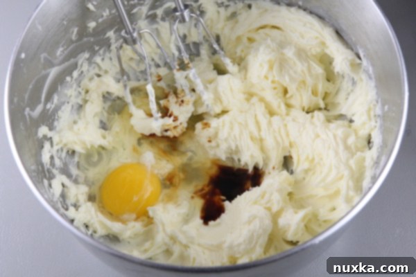 Adding egg and vanilla to butter mixture