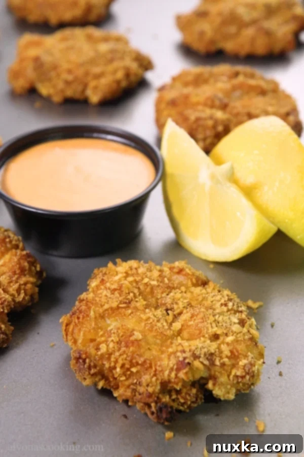 Close-up of golden brown crispy baked chicken fritters fresh out of the oven