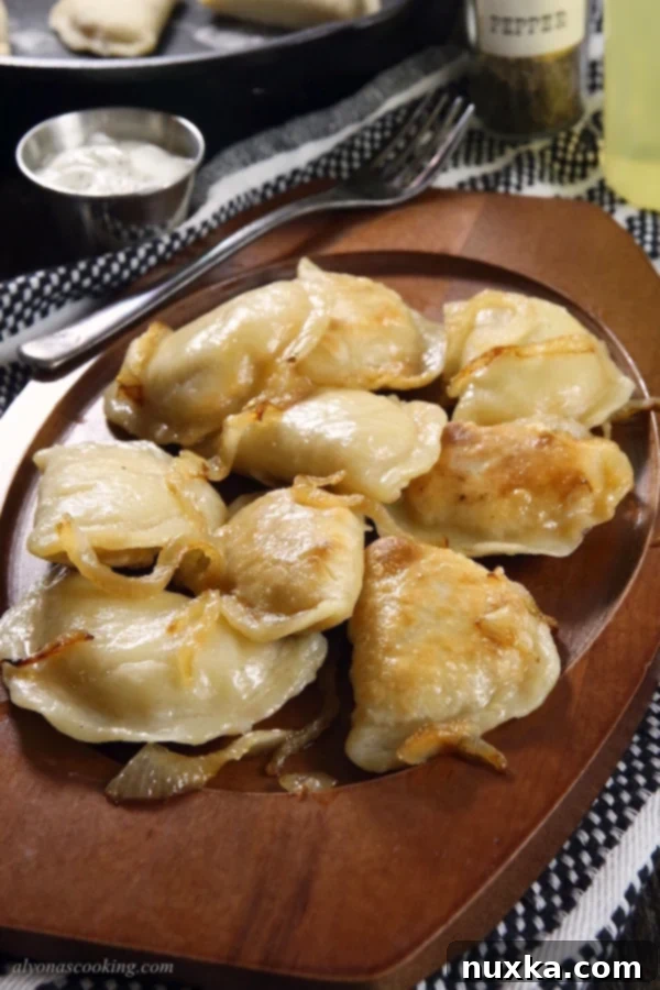 A bowl of freshly cooked and pan-fried homemade Polish pierogi.