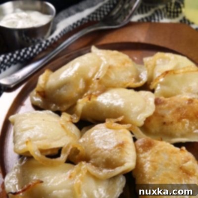 Homemade Polish Pierogi served with sour cream.