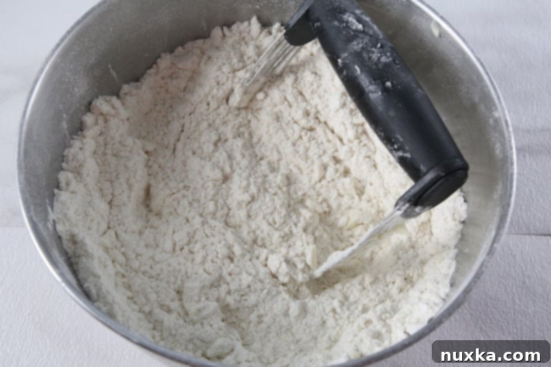 Flour, butter, eggs, and milk combined to form pierogi dough.