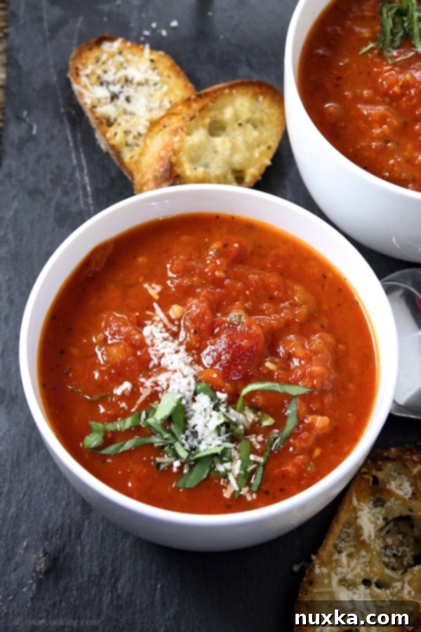 Close-up of a bowl of creamy tomato soup, showing its rich color and smooth texture