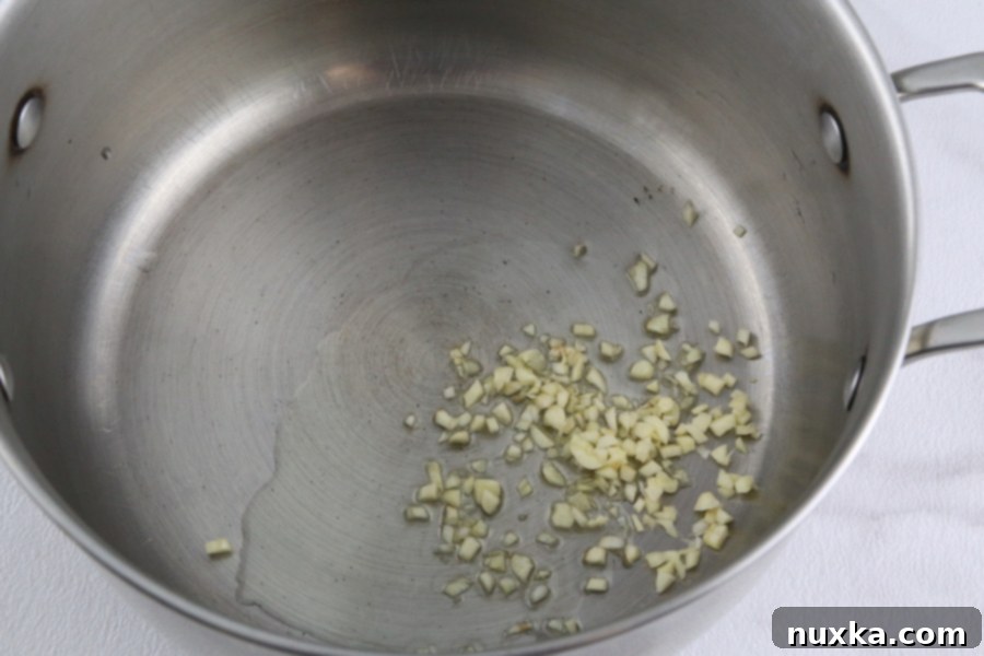 Garlic sautéing in olive oil, then adding canned tomatoes to the pot