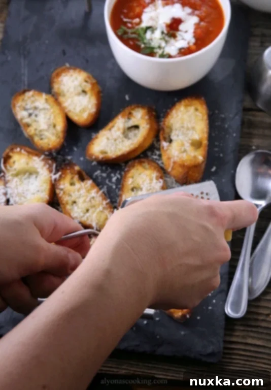 Freshly baked Parmesan Garlic Crostini on a wooden board, ready to be enjoyed