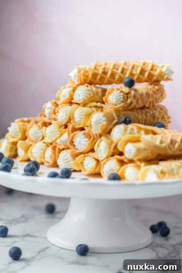 rolled pizzelle with cream that were made with a pizzelle maker called trubochki in Russian