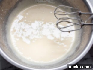 eggs and sugar in a bowl beaten until pale for cream-filled Pizzelles (Trubochki)