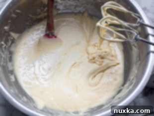 Pizzelle batter with flour, sugar, eggs, baking powder, vanilla, and butter