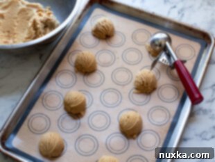 Freshly baked chewy peanut butter cookies cooling on a wire rack