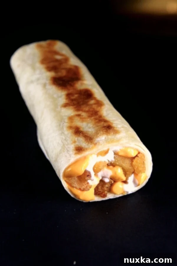 Delicious homemade Taco Bell Cheesy Potato Griller with melted cheese and sour cream