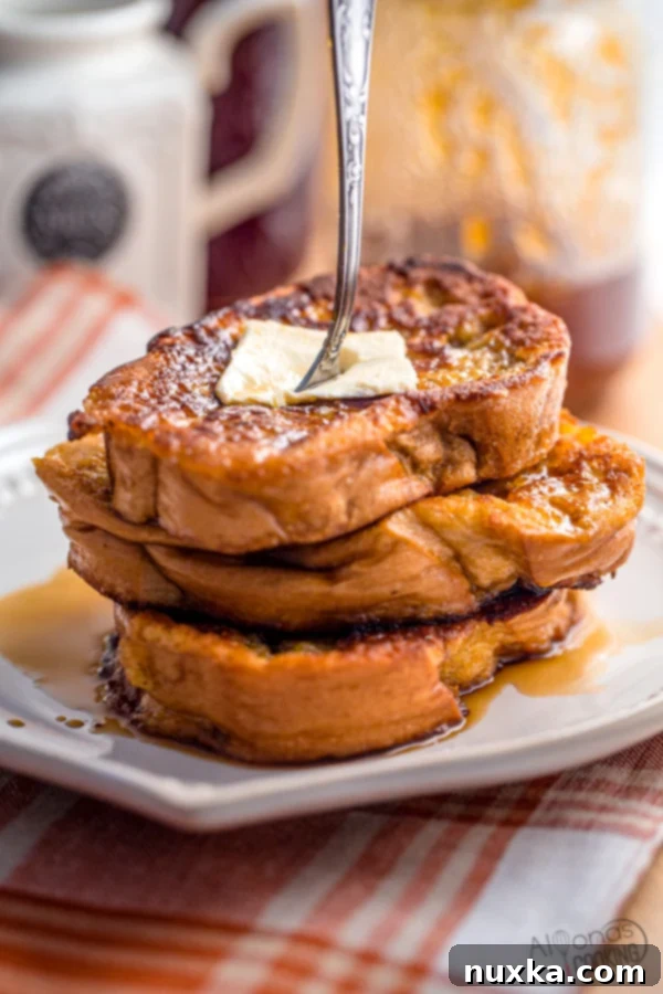 Perfectly golden French toast slices on a plate.