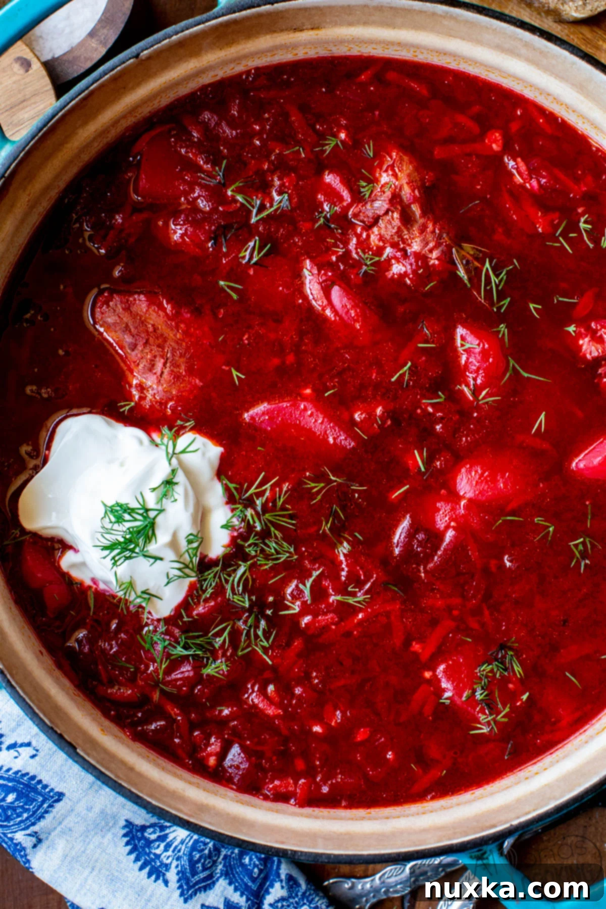 Authentic Borscht Recipe 2 A close-up view of a pot of simmering borscht, showcasing the rich texture and deep red color of the beet soup.