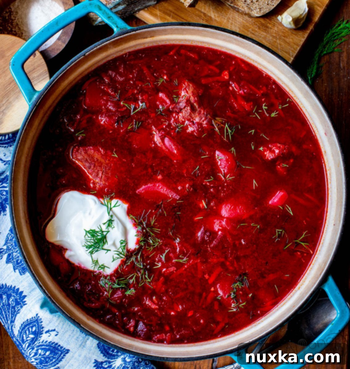 classic borscht, served with sour cream and dill A ladle filling a bowl with steaming, deep red borscht, topped with sour cream and dill, emphasizing its classic presentation.