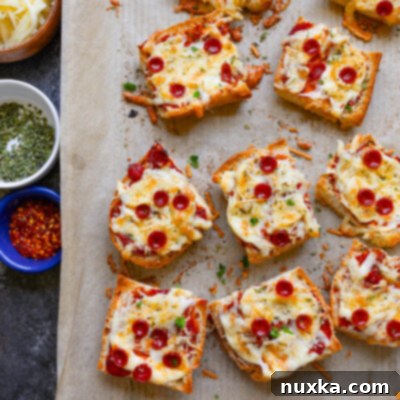 Crispy French bread pizzas with classic pepperoni and melted cheese on a baking sheet