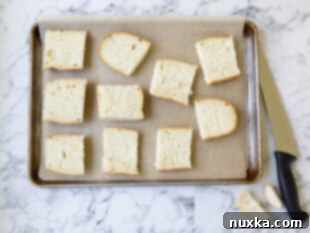 Slicing a loaf of French bread in half lengthwise to prepare for pizza toppings