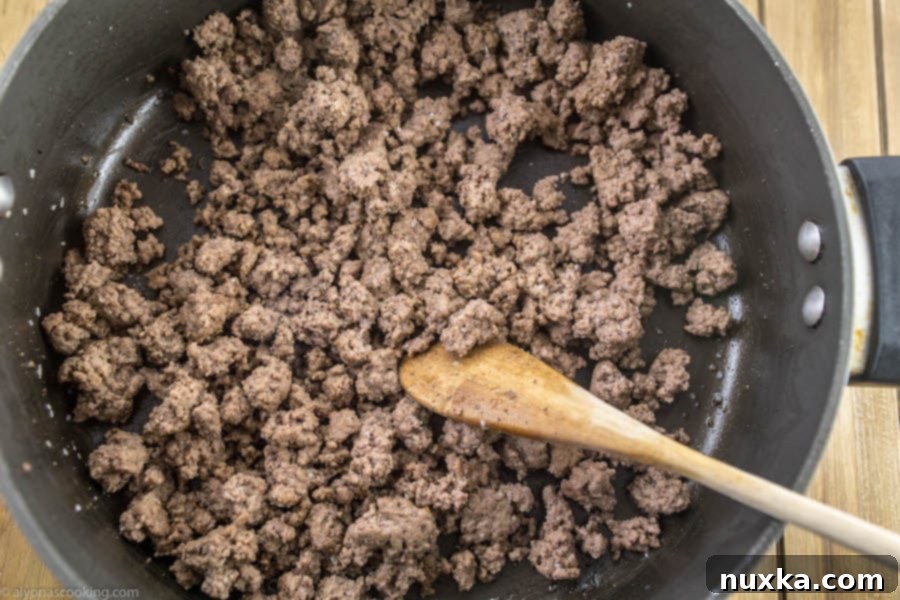 Ground beef browning in a skillet for Easy One-Pan Stroganoff