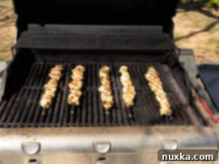 grilling chicken kabobs on an outdoor grill