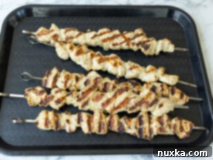 cooked chicken kabobs on a serving platter