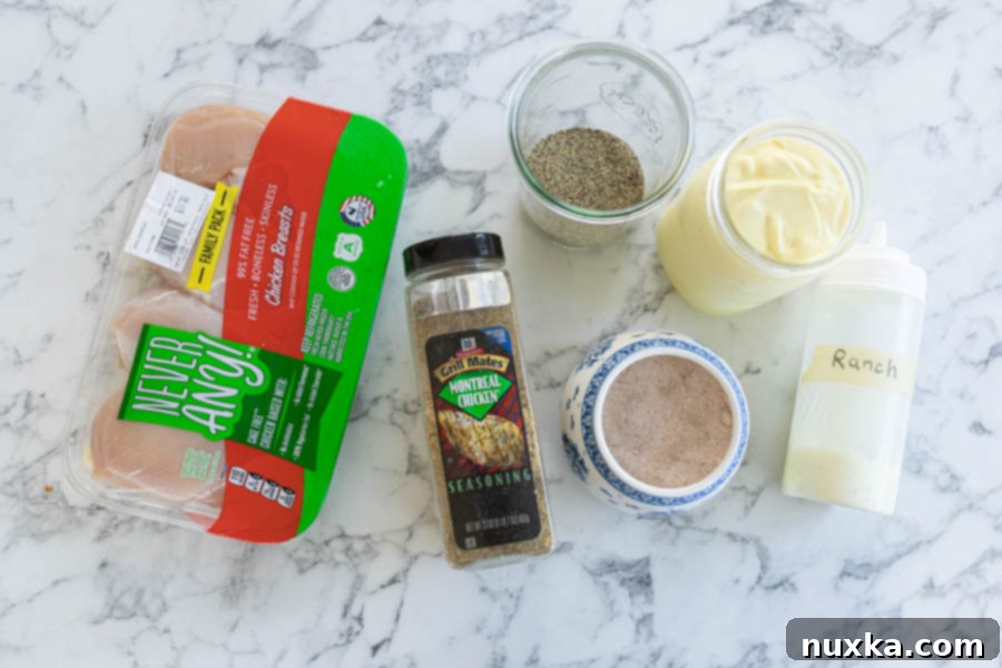 all ingredients for chicken kabobs laid out: chicken breasts, Montreal Chicken Seasoning, ranch dressing, mayonnaise, salt, pepper, vinegar