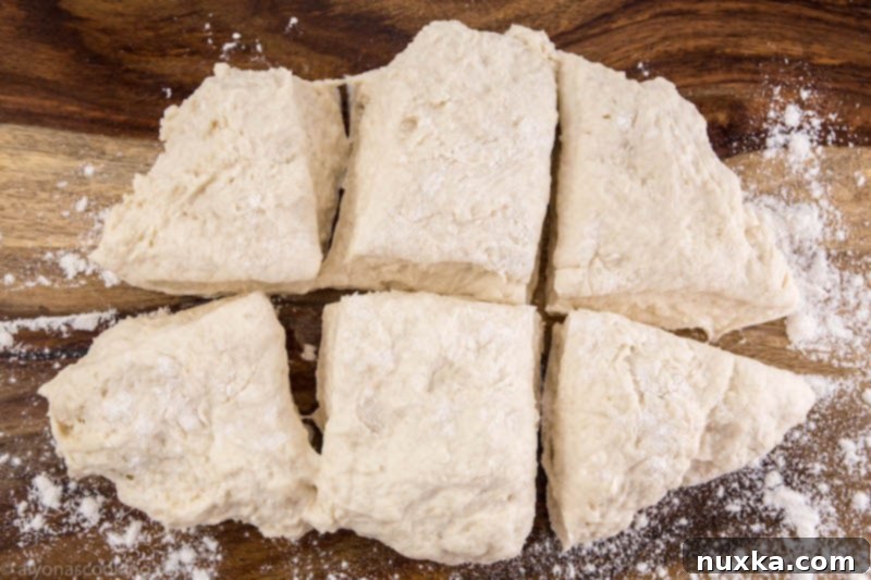 Rolling out homemade dumpling dough into a log