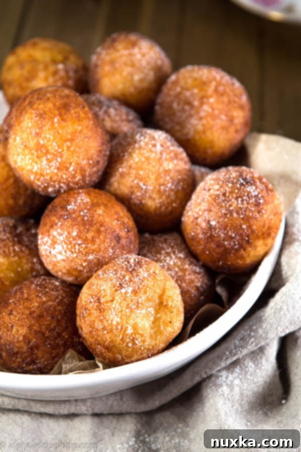 Ukrainian Ponchiki made with farmer's cheese, dusted with powdered sugar