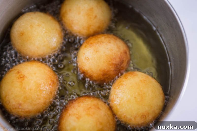Frying donut holes (Ponchiki) in hot oil