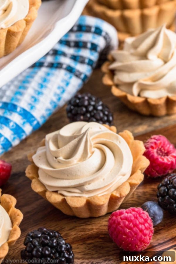 Crispy mini tart shells baked in fluted molds, resembling small baskets, ready to be filled.