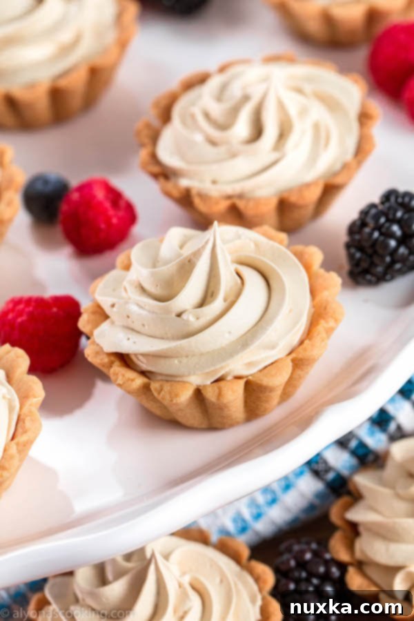 A beautifully arranged platter of filled Russian Korzinki, showcasing the delicate shortbread and creamy dulce de leche.