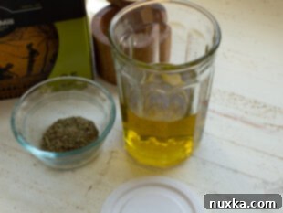 Ingredients for Bread Dipping Oil, including olive oil, Italian seasoning, garlic, and salt