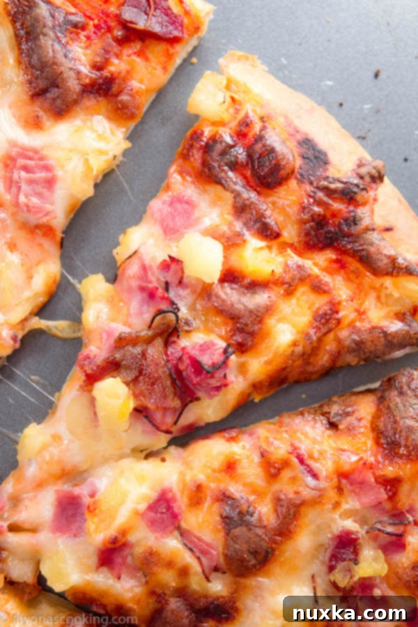 Freshly baked Hawaiian pizza on a pan