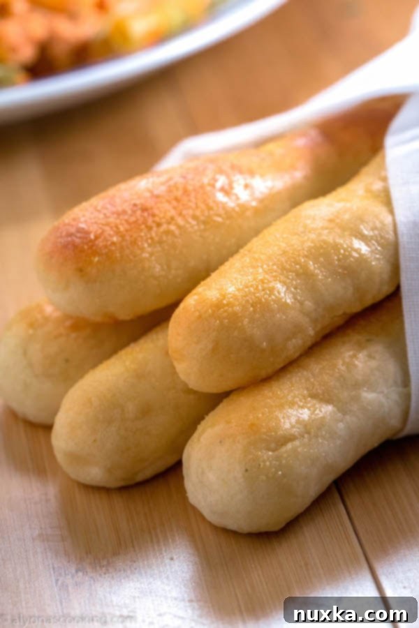 Homemade Olive Garden Breadsticks, perfectly golden and fluffy, ready to be served
