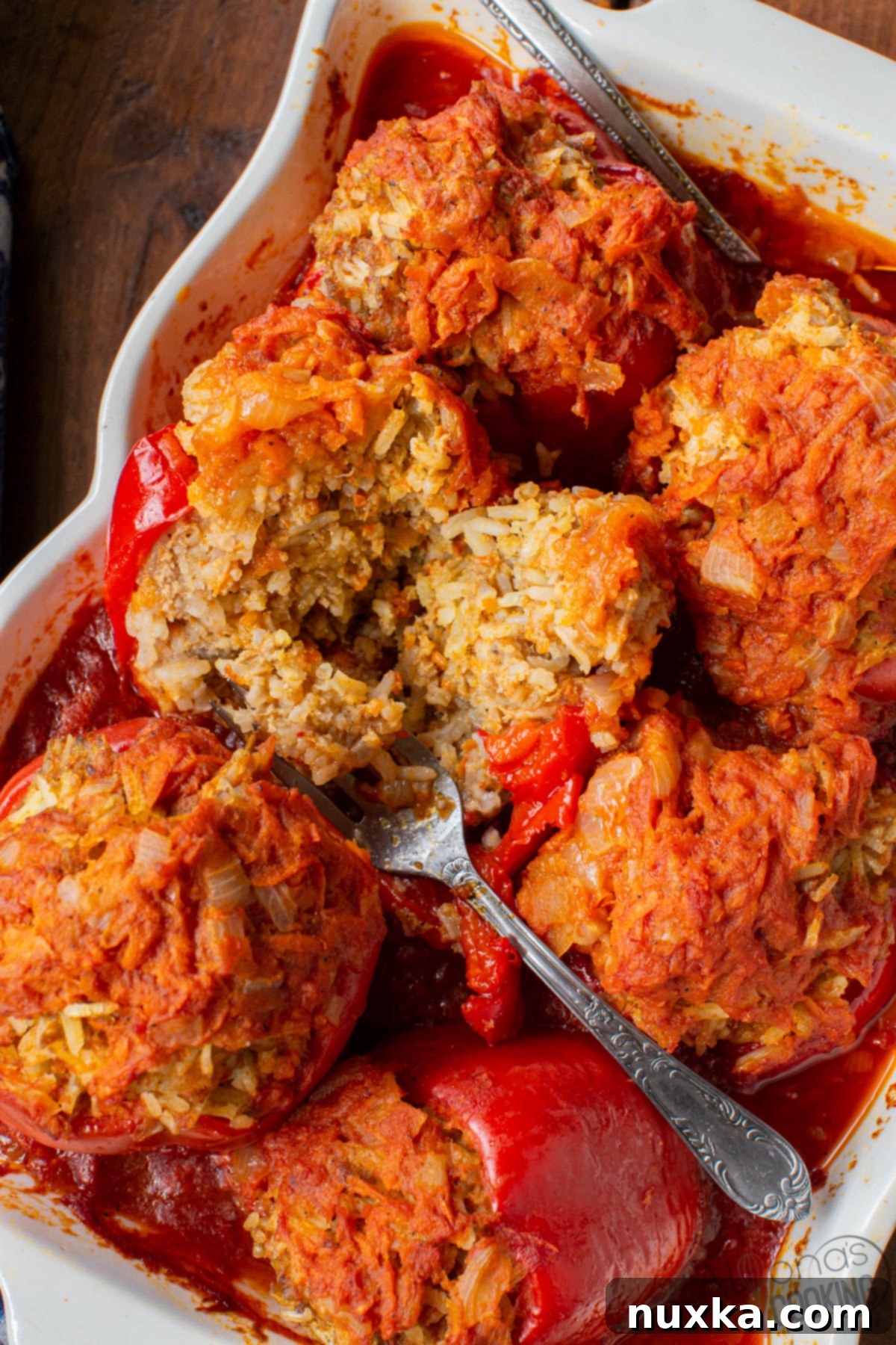 stuffed bell peppers cooking in tomato sauce