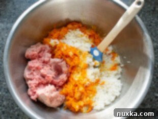 Mixing meat, rice, and spices for stuffed pepper filling