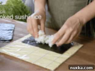 Cooling perfectly seasoned sushi rice to room temperature before use.