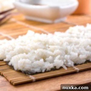 A bowl of freshly prepared sticky sushi rice, ready for making rolls.
