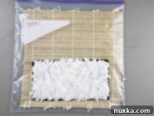 Spreading sushi rice on Nori seaweed sheet