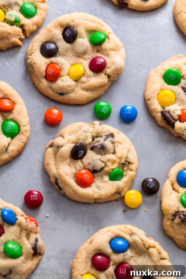 A stack of freshly baked M&M cookies on a cooling rack, perfectly garnished and ready to eat