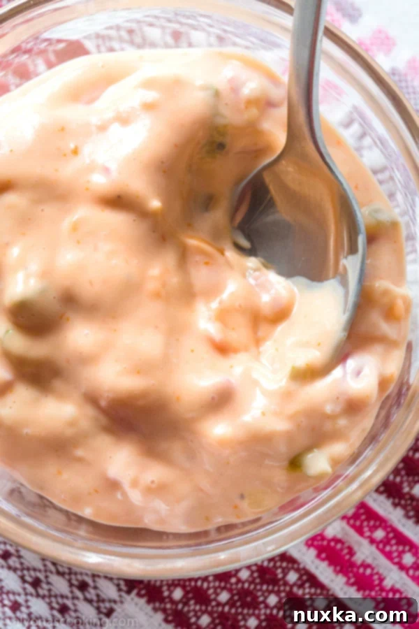 Close-up of freshly made Thousand Island dressing in a bowl, with a spoon