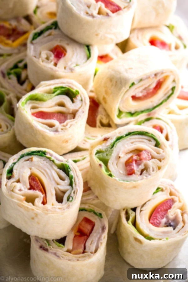 Costco Copycat Roll-Ups on a cutting board, ready to be sliced