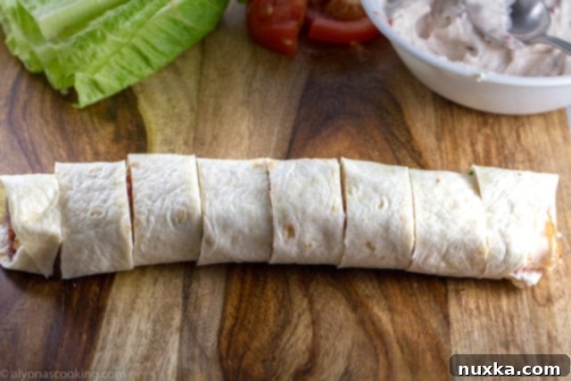 Sliced Costco Copycat Roll-Ups on a cutting board, ready to be served