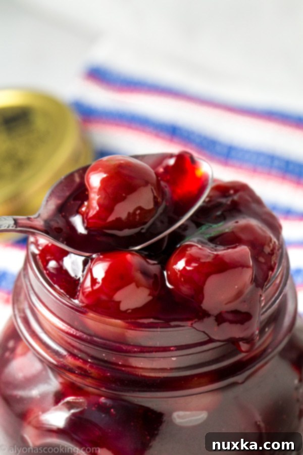 Closeup of homemade cherry pie filling simmering in a saucepan