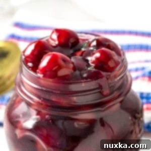 Cherry pie filling in a small bowl with a spoon