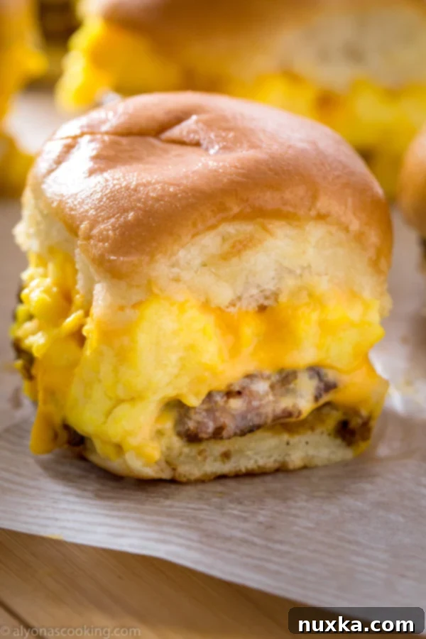 Delicious Sausage, Egg, and Cheese Breakfast Sliders on a platter, ready to be served, highlighting their golden-brown tops and savory filling.