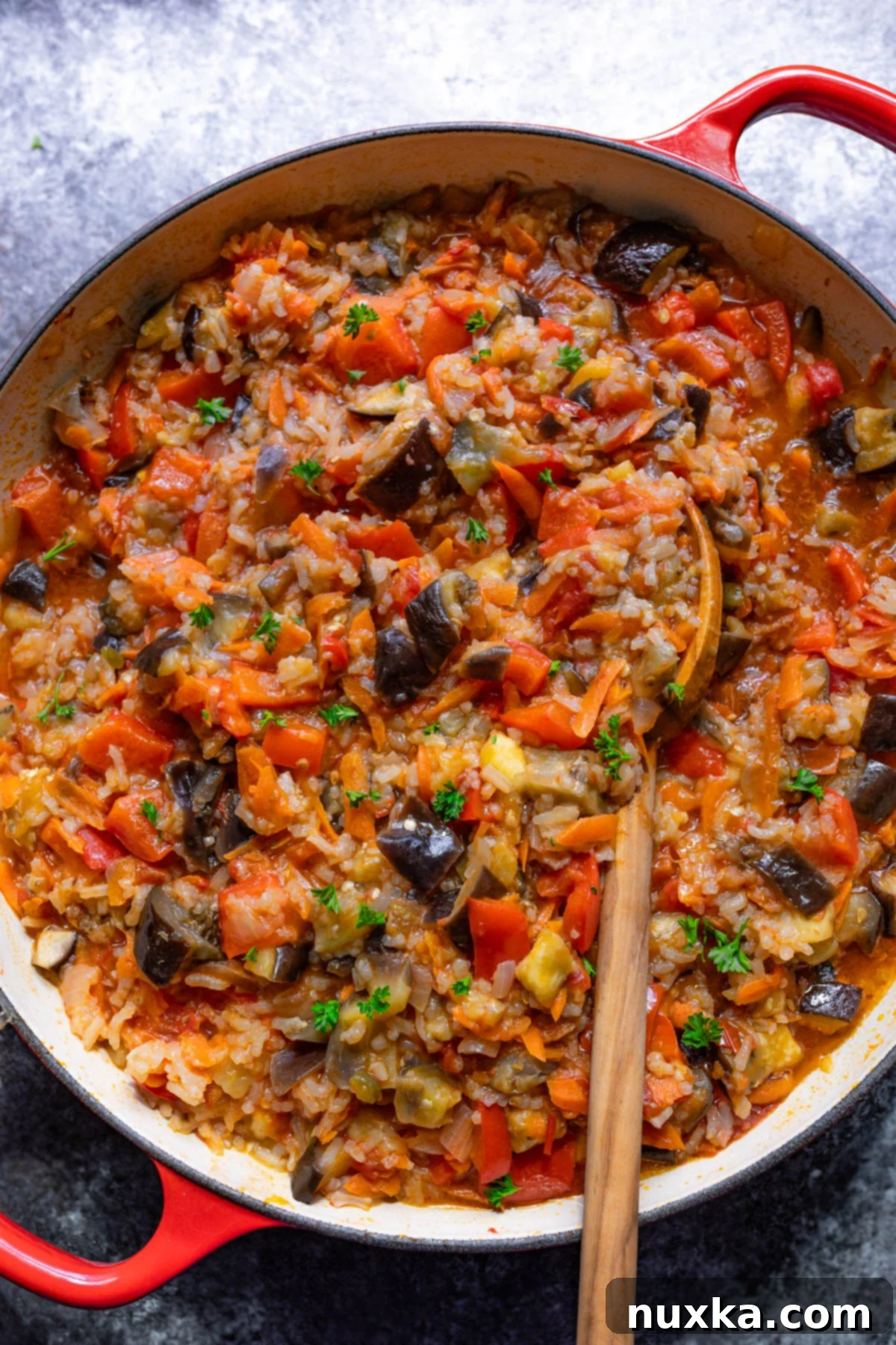 chunky fried eggplant recipe with tomatoes and vegetables in a pan