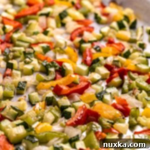 A vibrant mix of roasted vegetables, perfectly golden and ready to be served or stored.