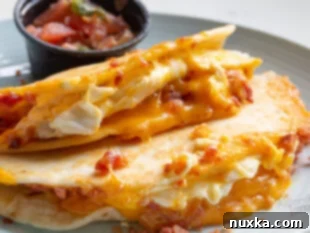 Serving crispy breakfast quesadillas with fresh salsa and sour cream.
