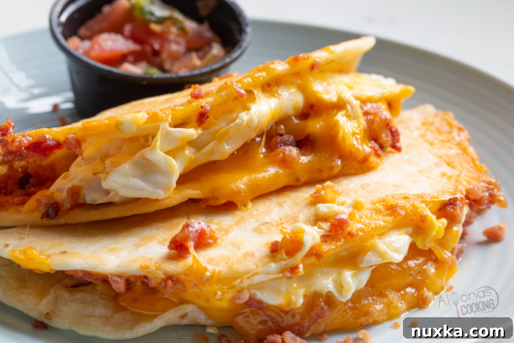 A perfectly toasted breakfast quesadilla, golden brown and filled with melted cheese, egg, and bacon