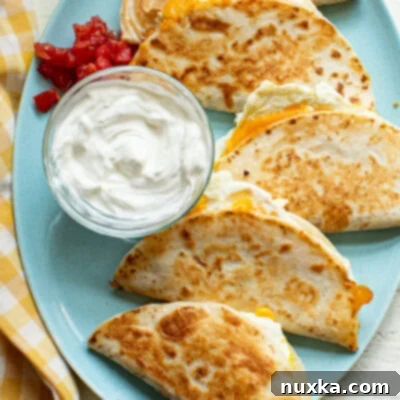 Bite-Sized Breakfast Quesadillas 6 Breakfast quesadillas on a blue plate, a complete and satisfying meal.